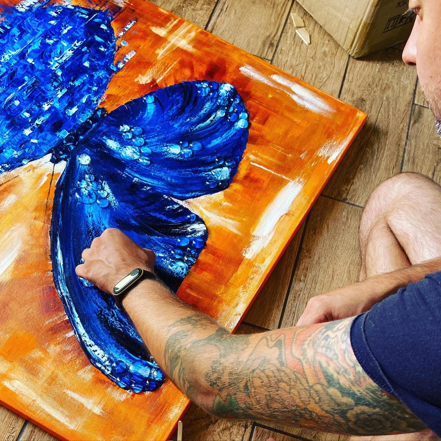 Boris Shestakov pressing cast drops onto the painted left wing of the canvas.